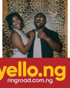 Hilda Baci wearing a white halter mini dress with beaded fringe beside partner Damilola Akinwunmi