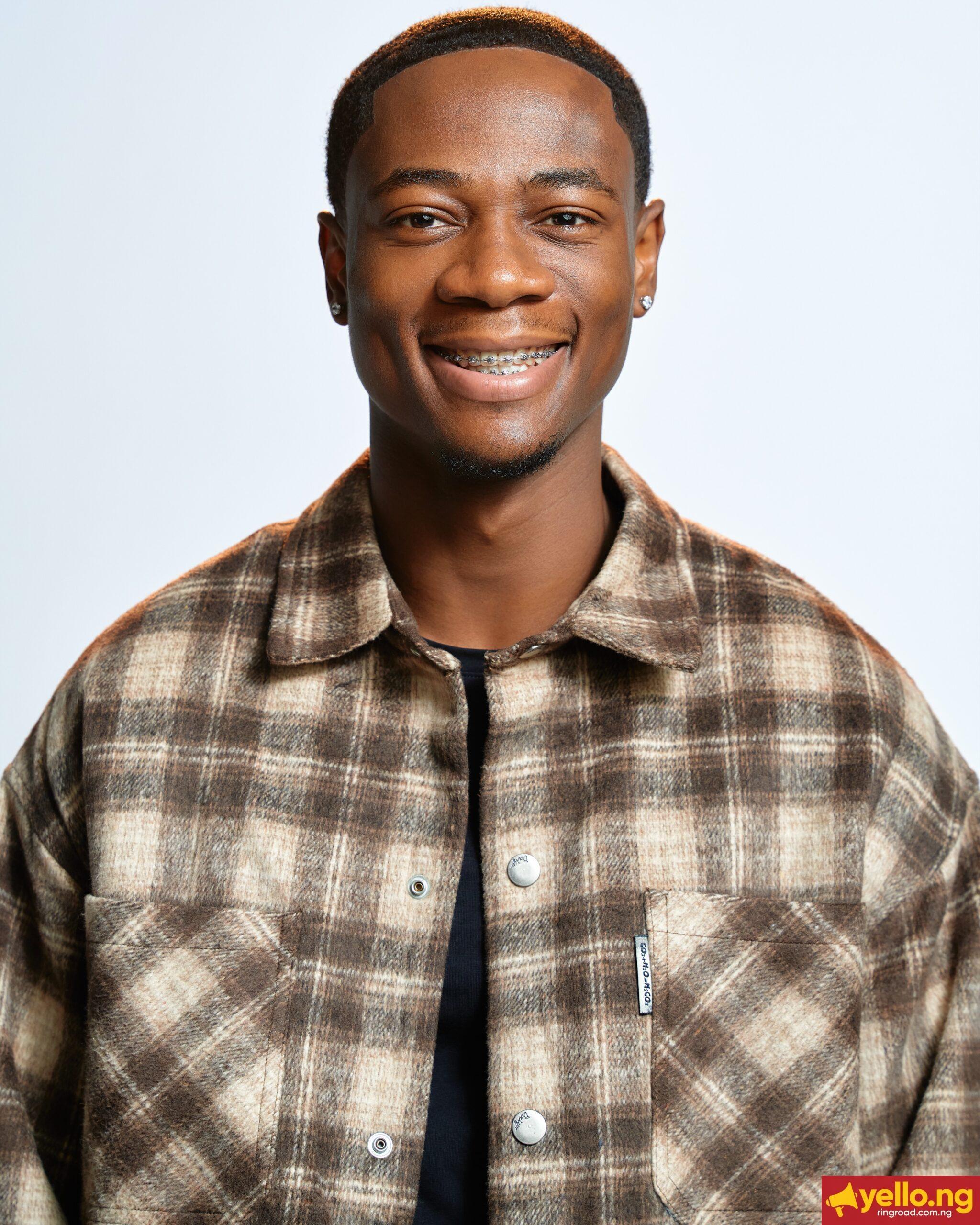 BBNaija Season 11 finalist Tram smiling in a brown patterned shirt